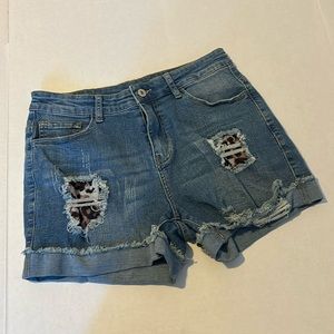 Stretch denim jean shorts with distressed and peek through Cheetah Print